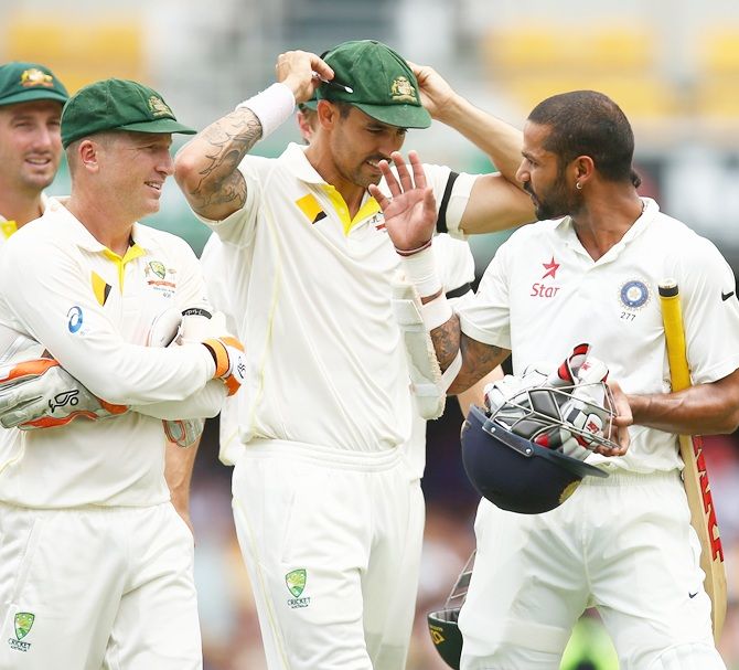 Shikhar Dhawan of India talks to Australian players