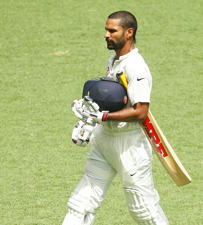 Shikhar Dhawan of India walks off the field after being dismissed by Nathan Lyon of Australia