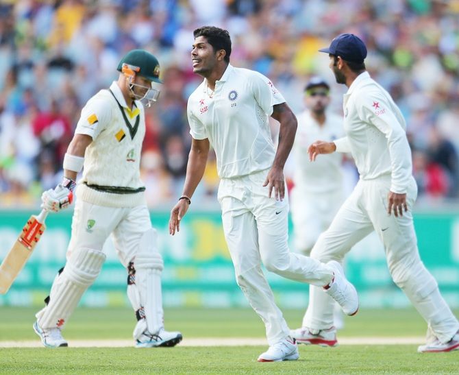 Umesh Yadav of India celebrates after dismissing David Warner of Australia
