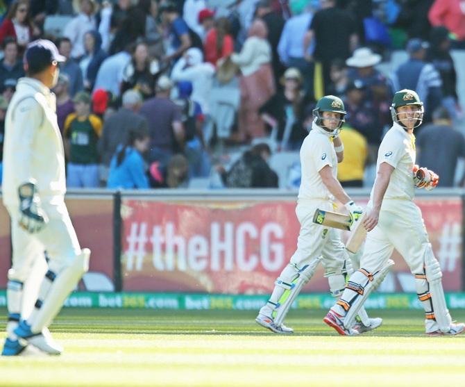 Australians Brad Haddin and Steve Smith exchange words with Mahendra Singh Dhoni during the Melbourne Test, December 26, 2014.