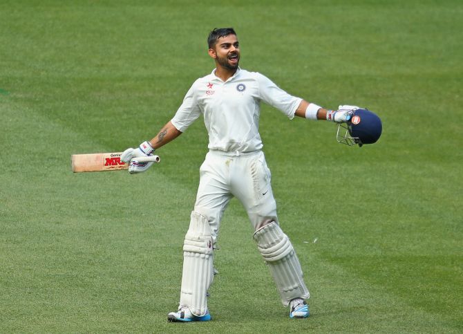 Virat Kohli exults after scoring a century in the third Test at the MCG, his third in the 2014 series. Kohli hit a brilliant 169 off 272 balls. He had scored 115 and 141 in the first Test at Adelaide. Photograph: Scott Barbour/Getty Images