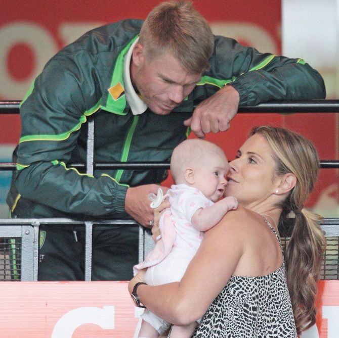 David Warner of Australia speaks to fiancee Candice Falzon as she holds their daughter Ivy Mae