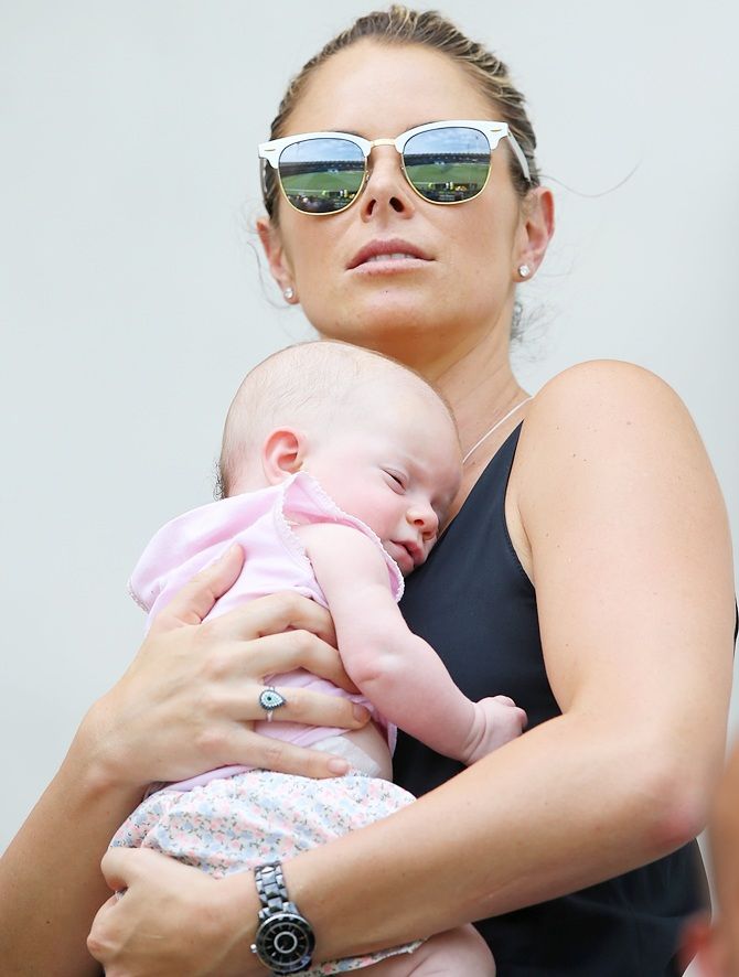Candice Falzon, Australian Professional Ironwoman and fiancee of David Warner of Australia kisses   their daughter Ivy