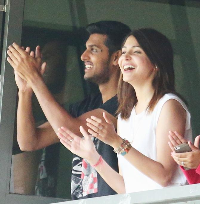 Anushka Sharma, girlfriend of Virat Kohli smiles as Kohli celebrates after reaching his century   during Day three