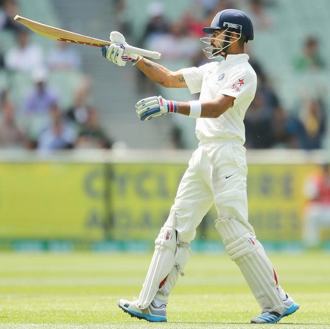 Virat Kohli of India celebrates as he reaches 50