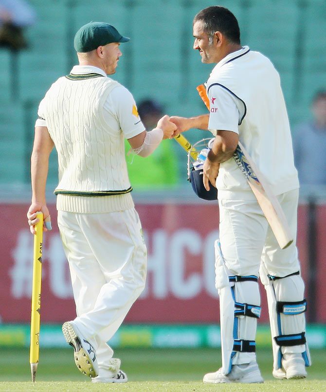 David Warner of Australia shakes hands with MS Dhoni of India as the game was called off for a draw during day five of the Third Test match between Australia and India at Melbourne Cricket Ground on Tuesday