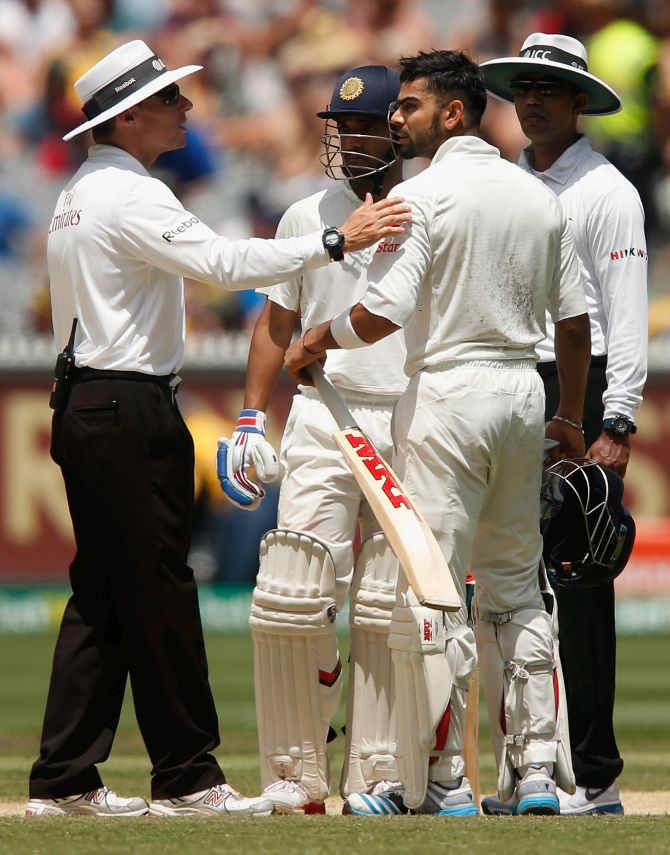 Umpire Richard Kettleborough speaks to Virat Kohli of India