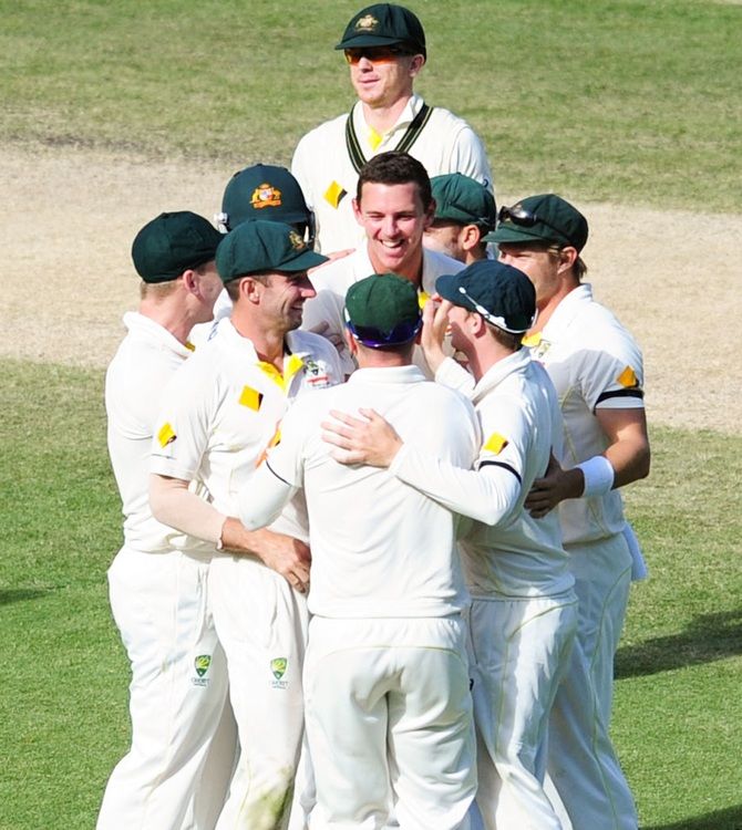 Josh Hazelwood celebrates a wicket with teammates on the final day of the Melbourne Test, December 30, 2014. Photograph: Vince Caligiuri/Getty Images