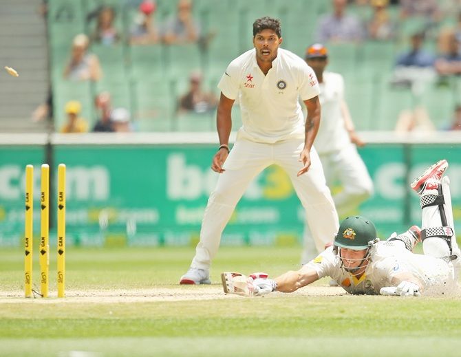 Umesh Yadav of India looks on as Shaun Marsh of Australia is run out