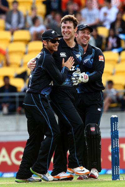 Team New Zealand celebrates the fall of an Indian wicket