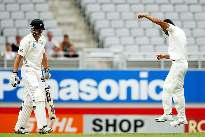 Peter Fulton of New Zealand (left) walks off after being dismissed LBW by Zaheer Khan