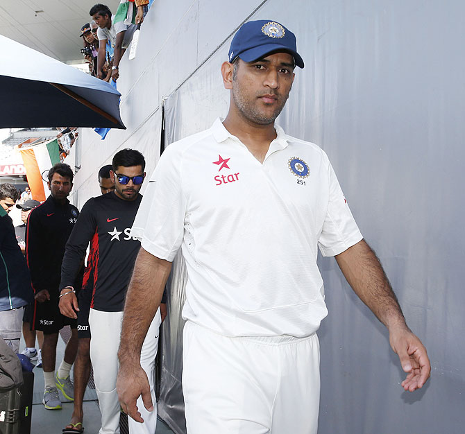 India captain Mahendra Singh Dhoni leads his team back to the dressing room after losing the first Test to New Zealand at Eden Park in Auckland