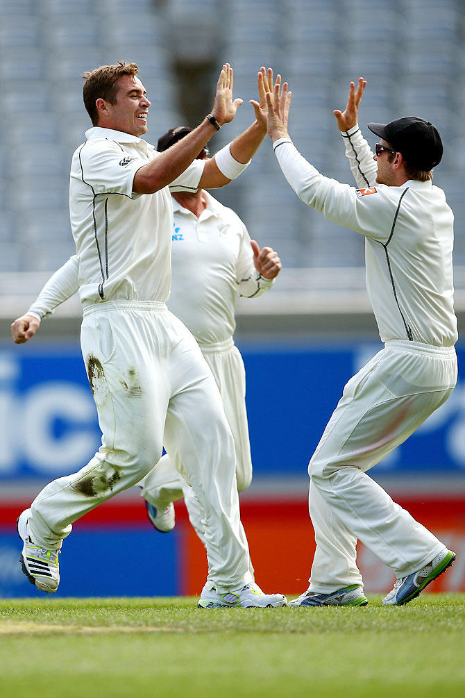 Tim Southee (left) celebrates the wicket of Cheteshwar Pujara