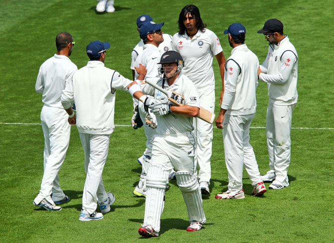 Ishant Sharma is congratulated after taking the wicket of Corey Anderson