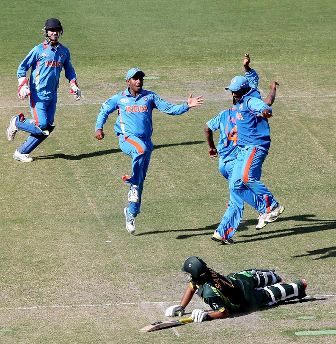 The Indian players celebrate the dismissal of Pakistan's Sami Aslam