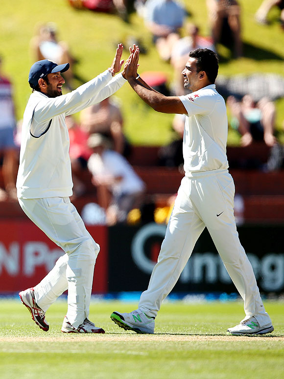 Zaheer Khan of India (right) celebrates the wicket of Kane Williamson with Cheteshwar Pujara on Sunday
