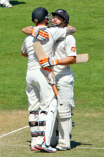 BJ Watling (right) celebrates his century with teammate Brendon McCullum
