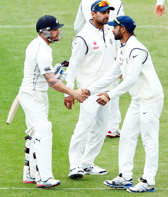 Brendon McCullum of New Zealand is congratulated by Shikar Dhawan of India after reaching 300 runs.