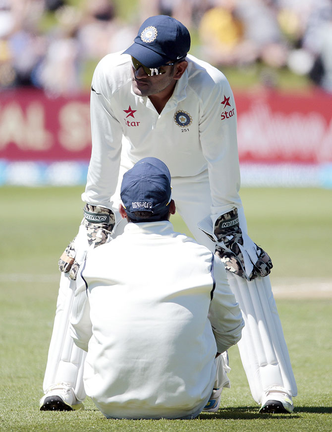 MS Dhoni talks to Murali Vijay (front) during the second Test on Sunday