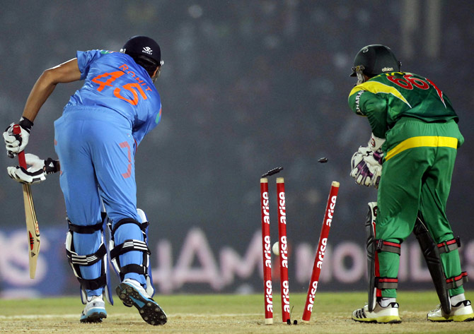 Bangladesh's wicketkeeper Anamul watches as Rohit Sharma is bowled