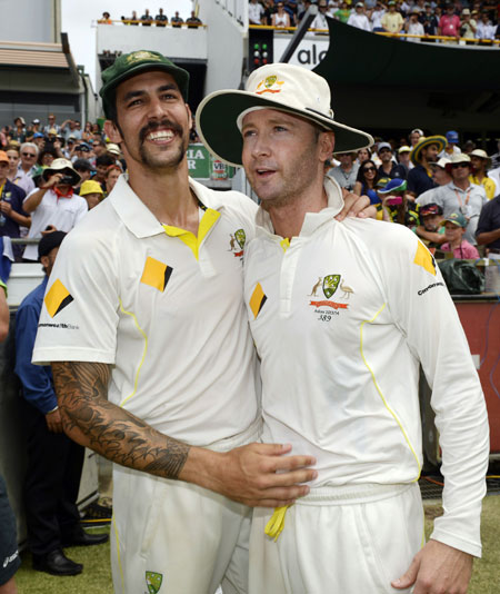 Australia's Mitchell Johnson (left) celebrates with captain Michael Clarke 