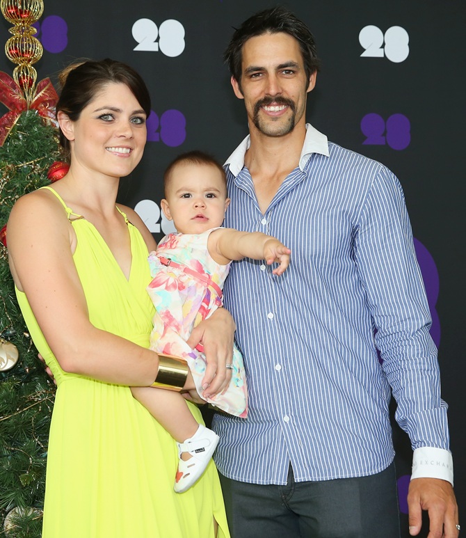 Mitchell Johnson of Australia poses with his wife Jessica Bratich-Johnson and daughter Rubika