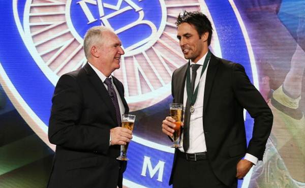 Mitchell Johnson talks with Allan Border on stage after winning the Allan Border medal