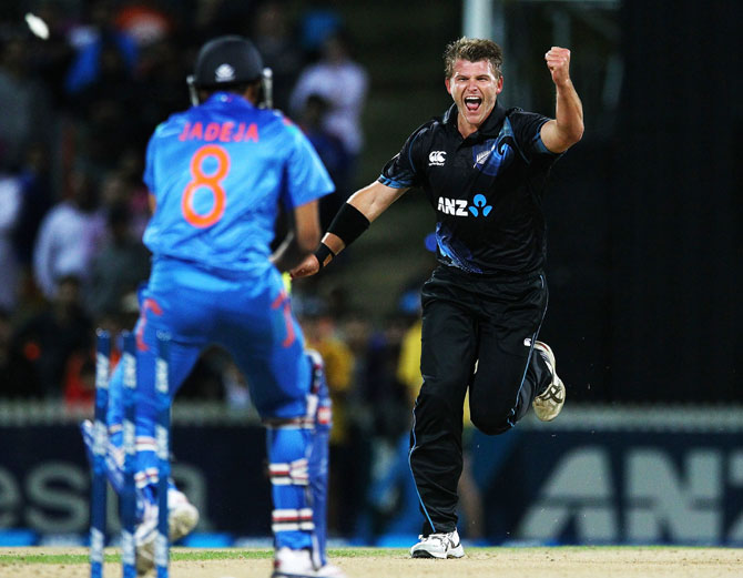 Corey Anderson of New Zealand celebrates after taking the wicket of Ravindra Jadeja of India 