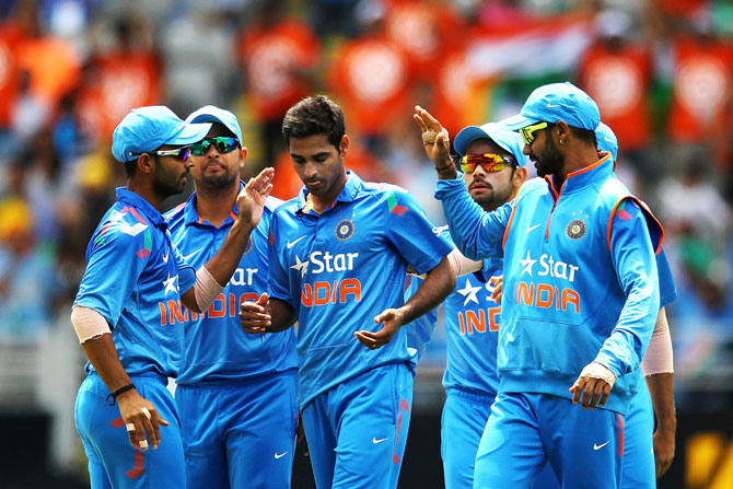 Bhuvneshwar Kumar of India celebrates with the team after taking the wicket of Jesse Ryder of New Zealand