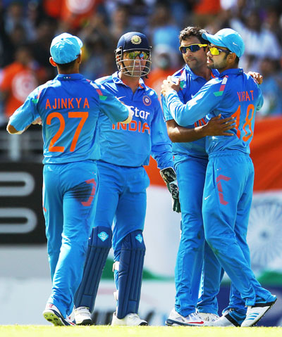 MS Dhoni of India celebrates with teammates Ravichandran Ashwin, Virat Kohli and Ajinkya Rahane