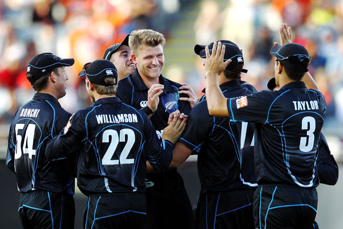 Corey Anderson of New Zealand celebrates after taking the wicket of Ajinkya Rahane of India
