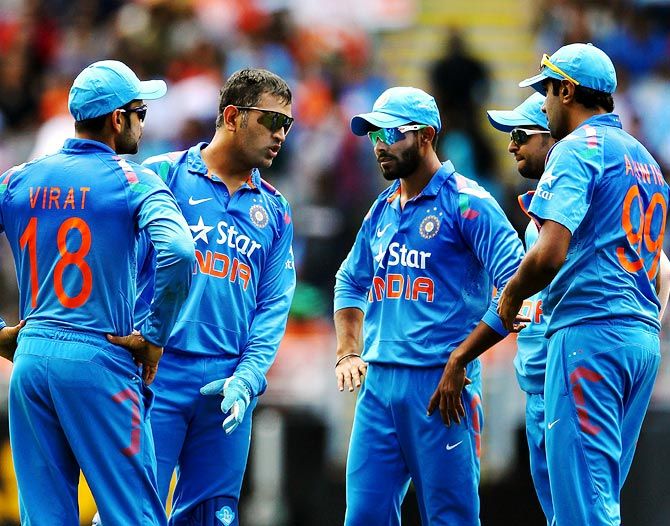 Mahendra Singh Dhoni confers with his team mates. Photograph: Anthony Au-Yeung/Getty Images