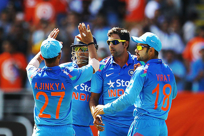 MS Dhoni of India celebrates with teammates Ravichandran Ashwin, Virat Kohli and Ajinkya Rahane after dismissing Corey Anderson of New Zealand
