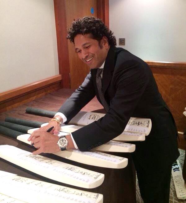 Sachin Tendulkar autographs a few cricket bats