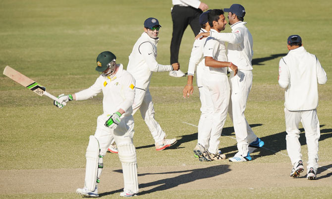Dhawal Kulkarni of India 'A' celebrates with team-mates after claiming the wicket of Phillip Hughes of Australia 'A'