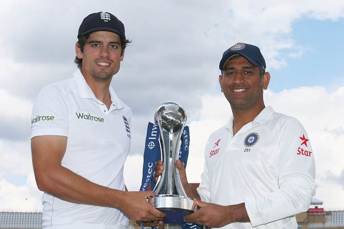England captain Alastair Cook (left) and Mahendra Singh Dhoni, captain of India, with the Investec trophy ahead of the first Investec Test series at Trent Bridge.
