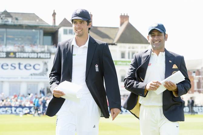 England captain Alastair Cook (left) and Mahendra Singh Dhoni, captain of India, walk out for the toss