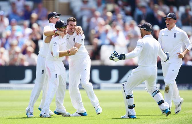 James Anderson celebrates with Ian Bell and Joe Root after dismissing Cheteshwar Pujara