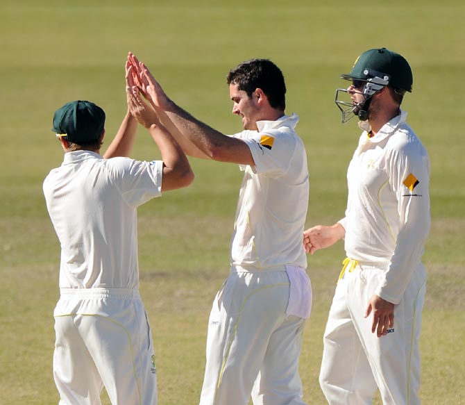 Ben Cutting (centre) of Australia A celebrates a wicket with his team mates