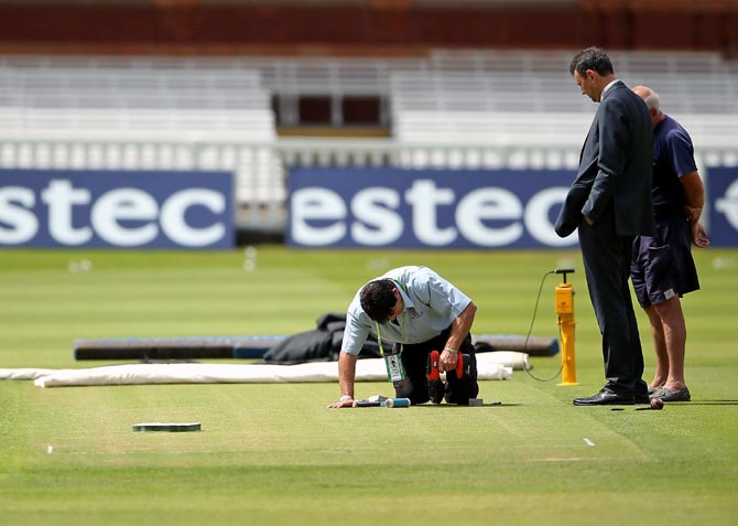Groundstaff work on the pitch at Lord's