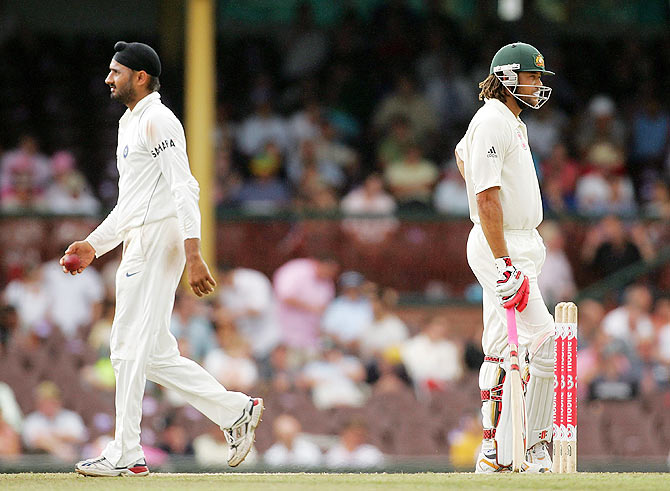 Harbhajan Singh of India walks past Andrew Symonds of Australia on his way back to his bowling mark during day four of the Second Test match between Australia and India at the Sydney Cricket Ground on January 5, 2008