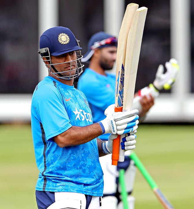 Mahendra Singh Dhoni checks his bats during an India nets session at Lord's in London
