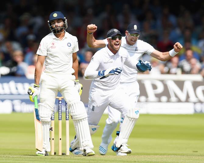 Ravindra Jadeja reacts after being given out lbw as Matt Prior and James Anderson (right) celebrate