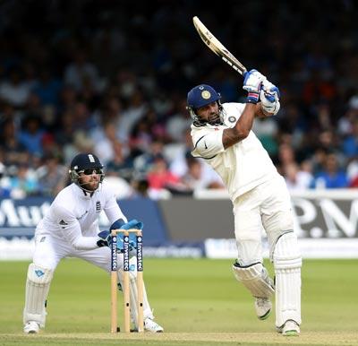 Murali Vijay (right) hits out as Matt Prior looks on