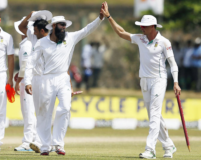 South Africa's captain Hashim Amla (left) and bowler Dale Steyn celebrate after their win in the first Test against Sri Lanka on Sunday