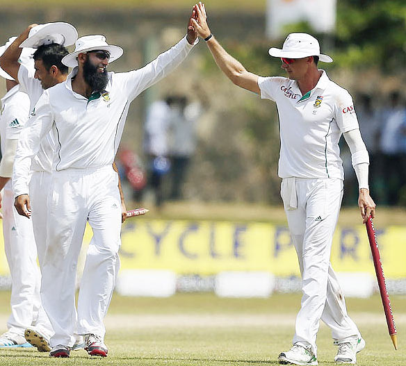  South Africa's captain Hashim Amla (left) and bowler Dale Steyn celebrate after their win in the first Test against Sri Lanka on Sunday