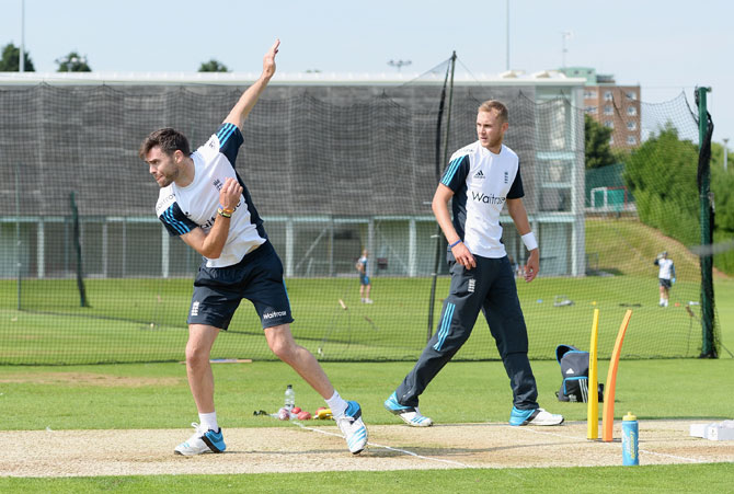 James Anderson bowls watched by Stuart Broad during an England training session
