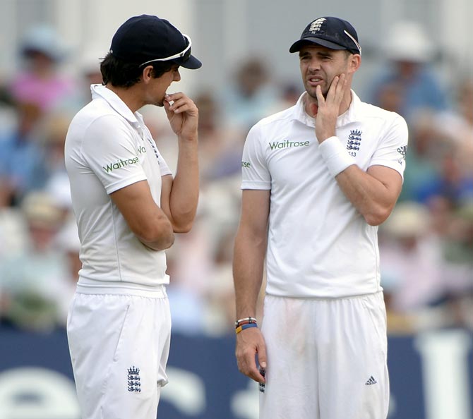 James Anderson (right) speaks to England captain Alastair Cook