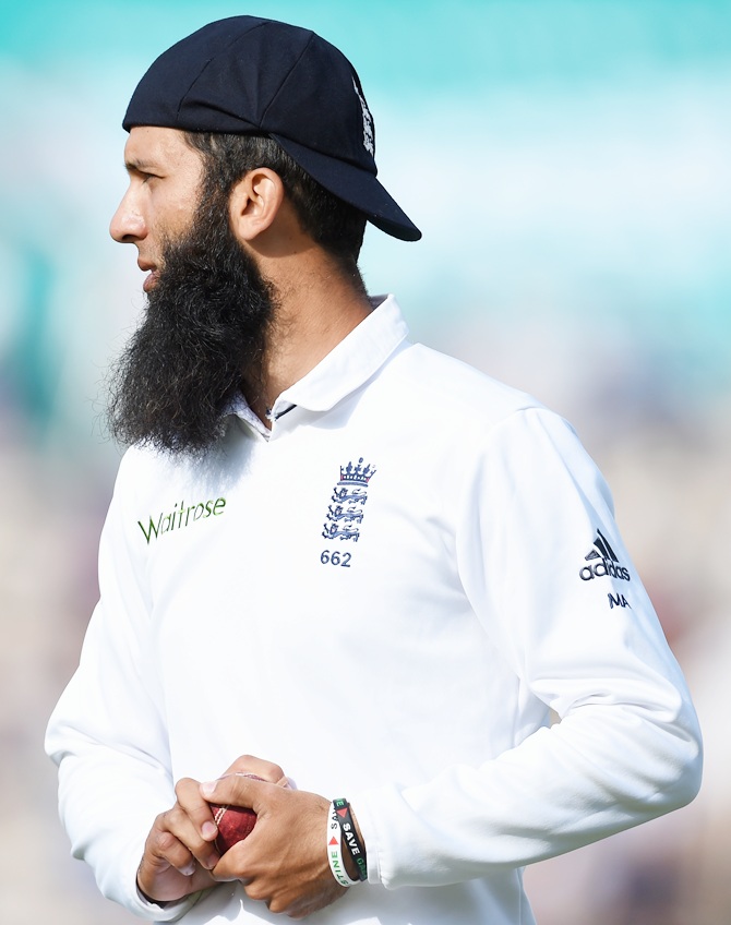 England player Moeen Ali looks on whilst wearing his cap back to front during day two 