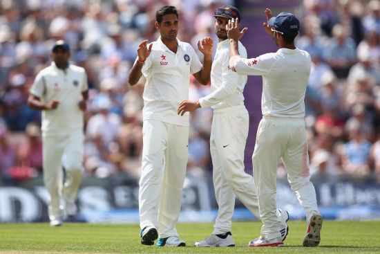 Bhuvneshwar Kumar, second left, of India celebrates taking the wicket of Joe Root of England